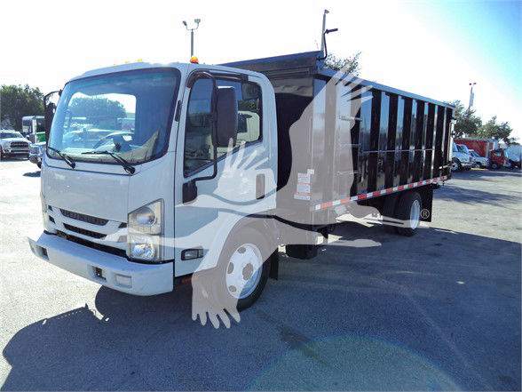 Isuzu dump truck in a parking lot, white cab, black dump bed. Visible text includes stock number and category data overlaying image.