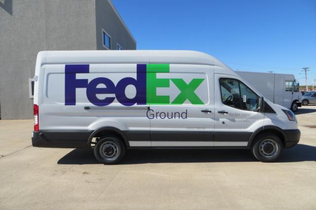 Ford Transit cargo van with FedEx Ground livery parked outdoors