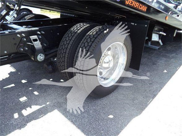 Truck wheel and dual rear tires on a Hino L6 chassis showing wheel and fender area.