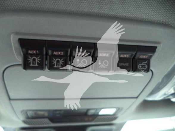 Dash area showing multiple AUX switches labeled AUX 1, AUX 2, AUX 3, AUX 4, AUX 5, AUX 6 and some with a spare label, plus a small light panel.