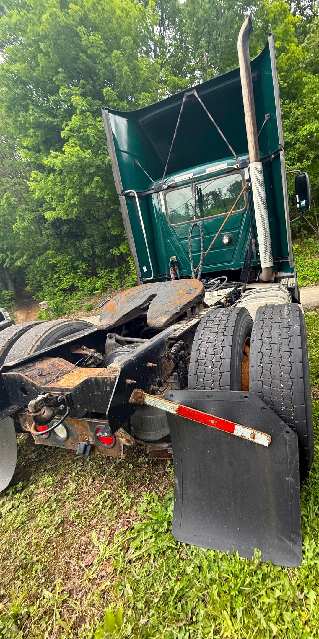 Truck cab and rear frame of a 2016 Mack CXU 612 with fifth wheel and mud flaps visible.