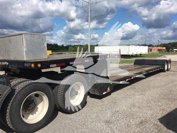 XL Specialized XL70MDE lowboy trailer showing dual rear axles with white wheels and wooden deck.