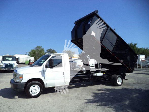 Ford E450 dump truck with raised black dump body and white cab, side view. Side text not legible.