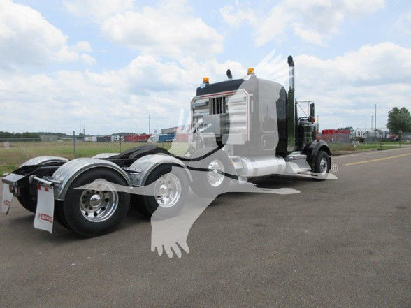 Kenworth W900B truck tractor in a parking lot, side view showing cab and dual rear axles. Watermark across image. 