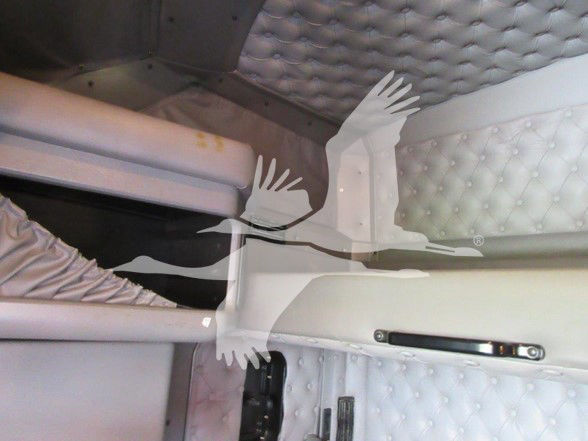 Kenworth W900L sleeper cab interior showing quilted headliner and window shade with stock number U8249.