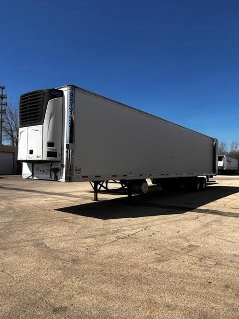 2015 CIMC Cool Globe refrigerated trailer with dual-axle chassis and a vertical refrigeration unit at front. Side panels are blank, trailer stands on concrete lot under clear blue sky.
