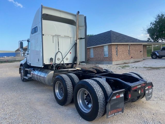 2015 Mack CXU613 tractor with sleeper cab showing rear chassis and dual rear axles.