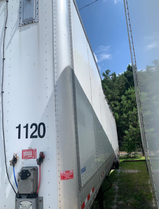 Trailer side showing the number 1120 and connection box with red and blue cables on a white Vanguard VXP trailer.