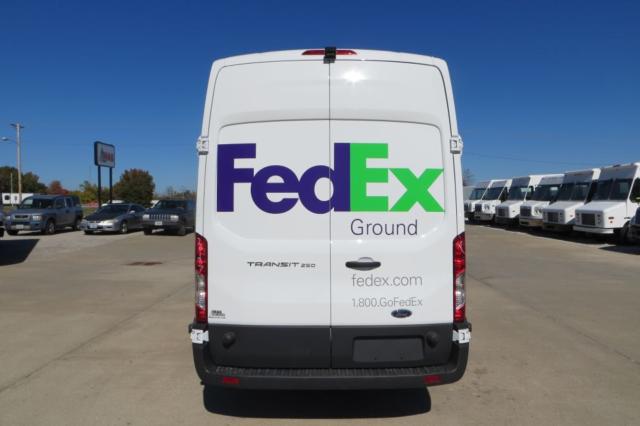 Ford Transit van rear view with FedEx Ground logo on white cargo doors.