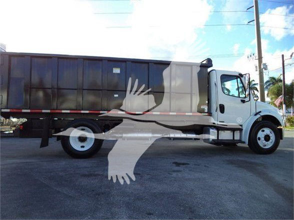 Truck showing cab and cargo bed of a 2012 Freightliner Business Class M2 106 in a dealership lot.
