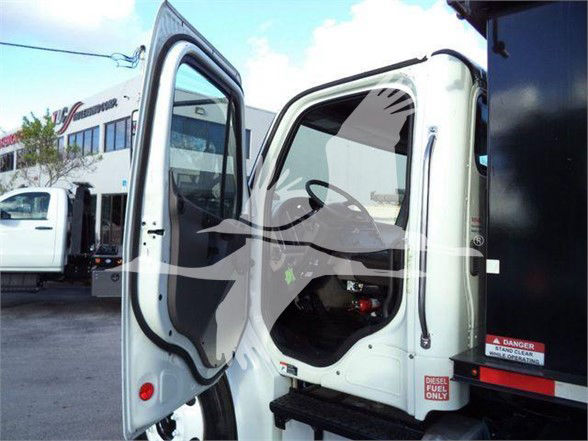 Truck cab open door with interior, showing 'DIESEL FUEL ONLY' sticker and cabin area, Freightliner M2 106 style.