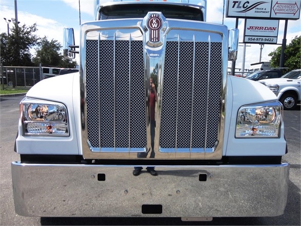 Kenworth W990 front view showing large chrome grille, headlights, and bumper.