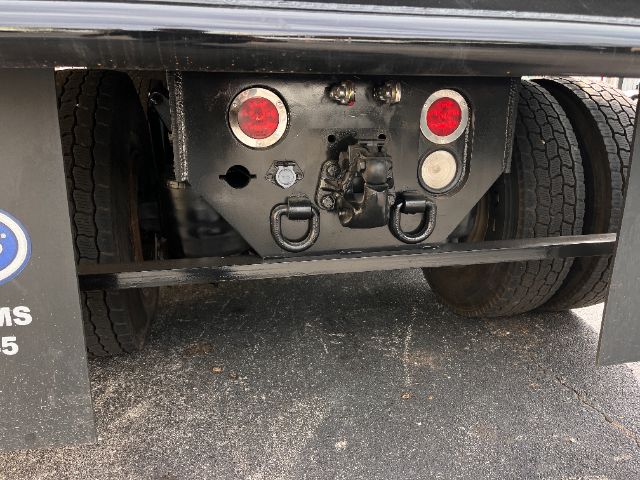 Rear view of a Freightliner Cascadia 125 truck chassis showing the bumper, rear lights, and towing/hitch hardware.