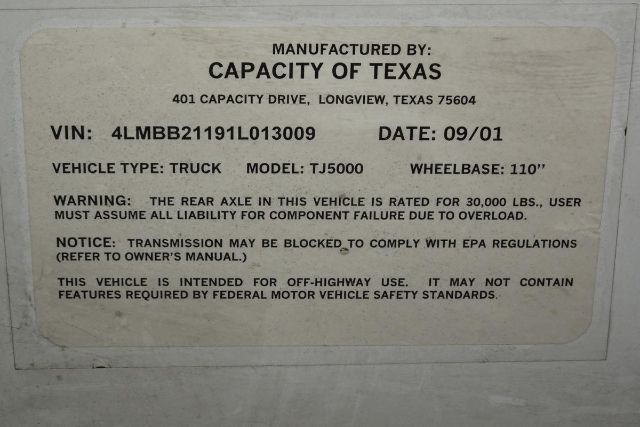 Manufactured by Capacity of Texas label on vehicle stating VIN 4LMBB21191L013009, date 09/01, vehicle type truck, model TJ5000, wheelbase 110, warning about rear axle rating 30,000 lbs, EPA compliance note.