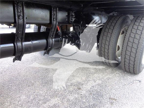 Freightliner Business Class M2 106 undercarriage showing dual rear axles and drivetrain components.
