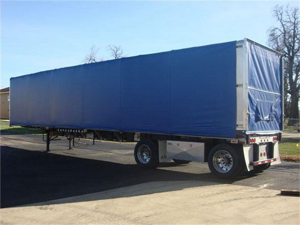 Fontaine AERO CONESTOGA tarp system trailer with blue curtain side and silver frame showing rear and side view.