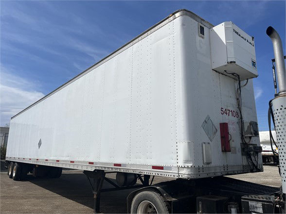 Truck trailer side view shows a white Wabash dry van with a refrigeration unit mounted at the front corner and stock number 547108 marked on the rear.