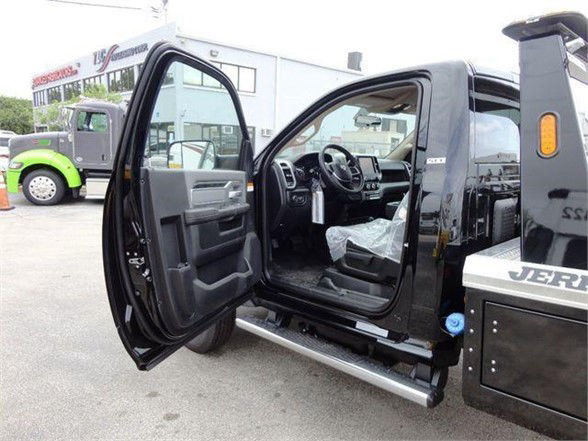 Ram 4500 SLT pickup truck interior with driver door open, showing dashboard, steering wheel, and side steps.