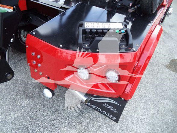 Ram 5500 tow truck rear bumper area with two circular lights and a black toolbox, red body panels, and a license plate holder reading 314-979-9422.