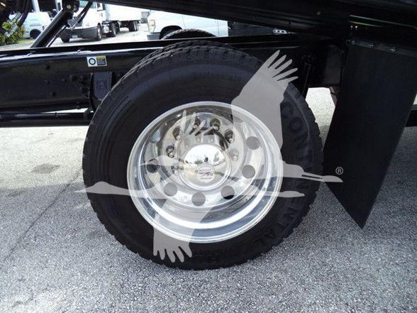 Kenworth T280 truck wheel and tire visible underbody; chrome wheel with lug nuts; part of the truck frame and fender