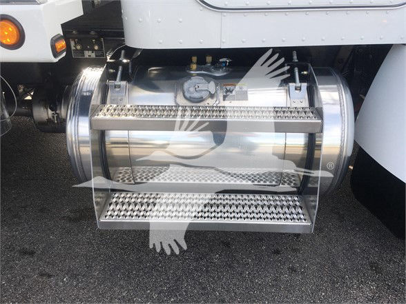 Truck fuel tank with chrome steps on side of 2022 Peterbilt 337 showing stainless steel tanks and steps.