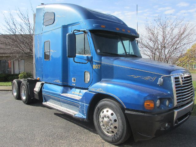 Blue 2007 Freightliner Century conventional sleeper tractor showing 6-wheel rear and aerodynamic cab with decals and stock number 1785.