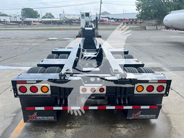 XL Specialized XL110HDGS18 Guardian 55-ton lowboy trailer rear view showing multiple axles, taillights, and mud flaps with Specialized Trailers logos.