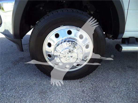 Front wheel of a 2023 Ram 4500 SLT showing chrome hub and tire with overlay graphic.