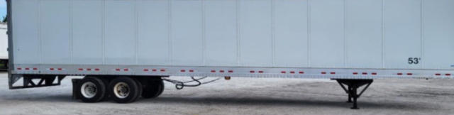 Trailer side view showing undercarriage and swing-out support legs with wheels, utility trailer equipment.