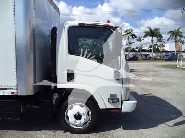 Isuzu NRR box truck cab in view showing front wheel and door area with cargo box behind.