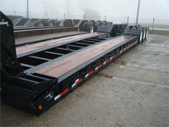 Talbert 55SA flat level deck HRG trailer showing wood deck and black steel frame with red-and-white reflective decals.