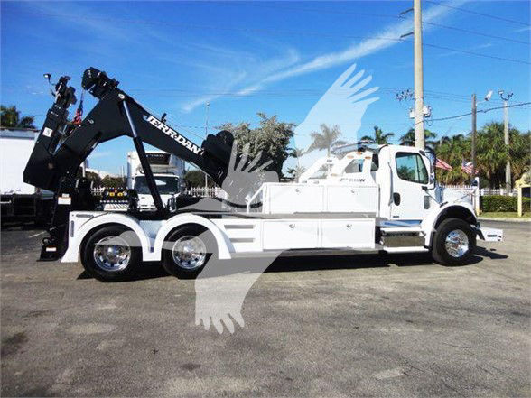 2012 Freightliner BUSINESS CLASS M2 106 tow truck with crane; side view shows white cab, black crane arm, dual rear axles, chrome wheels, and various compartments.