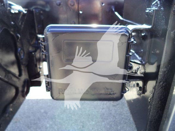 Truck rear with power unit or battery box mounted on the chassis showing Freightliner components and a watermark bird image.