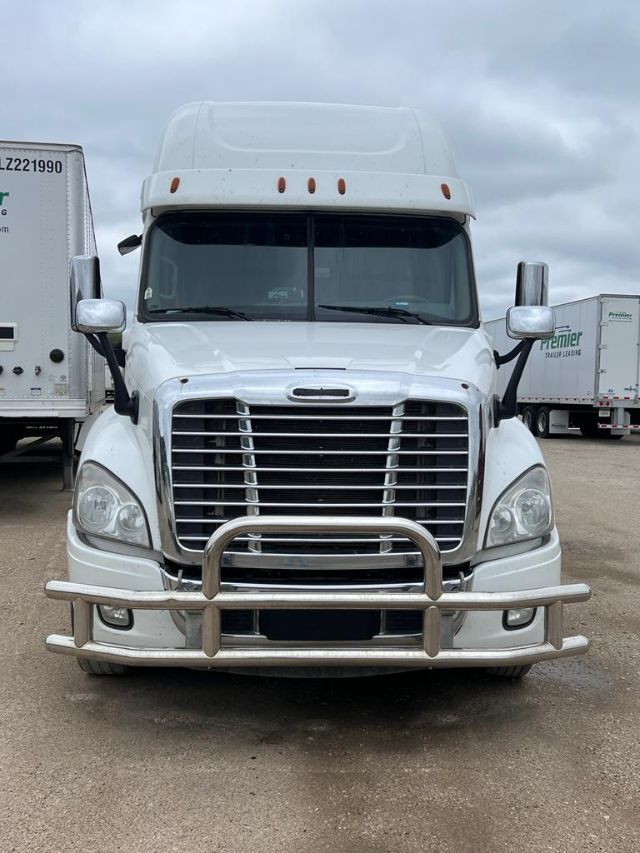 Front view of a white 2017 Freightliner Cascadia sleeper cab truck with chrome grille, bumper guard, and dual side mirrors.