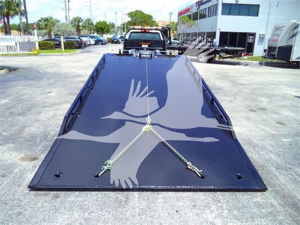 Flatbed tow truck bed with chains on a Chevrolet Silverado 6500HD listing image.