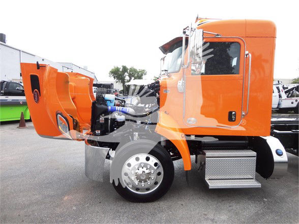 Orange 2022 Peterbilt 337 truck with hood open, showing engine bay and side profile.
