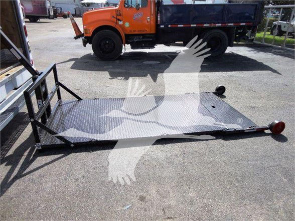Ford E-350 SD box truck with an empty ramp and hitch, orange cab in background, VIN 1FDWE3FL5FDA09434 not clearly visible on ramp.