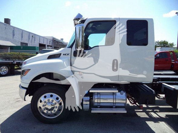Side view of a white 2025 International MV tow truck with stock number J18825FM, showing the cab and front wheel; no visible text other than model badge on the side.