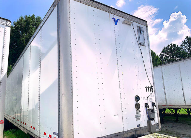 Vanguard VXP utility trailer in white with a blue V logo, rear view showing doors, wiring, and stock number 1115.