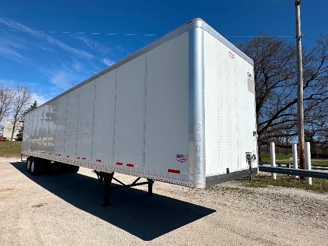 2015 Wabash DuraPlate dry van trailer with white exterior, elevated front corner, and rear entry doors; VIN 1JJV532D5FL840508 visible faded on nose.