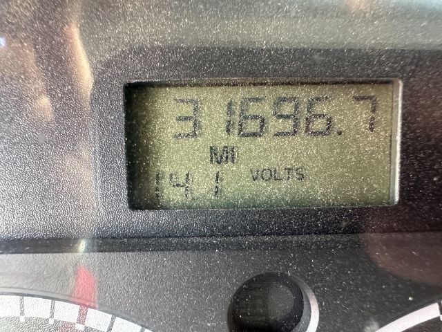 Digital voltmeter display showing 3 1696? 7 volts and 14 volts? The text reads NUM VOLTS 14.1? It appears to be a DC voltmeter in a Freightliner M2 cab.