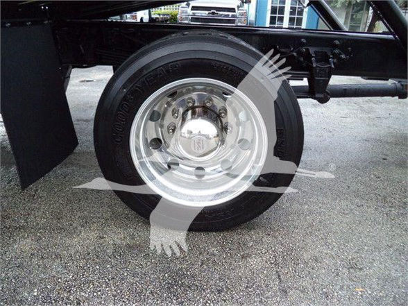 Wheel and tire on a 2024 Ford F750 SD truck showing chrome hubcap and tire markings.