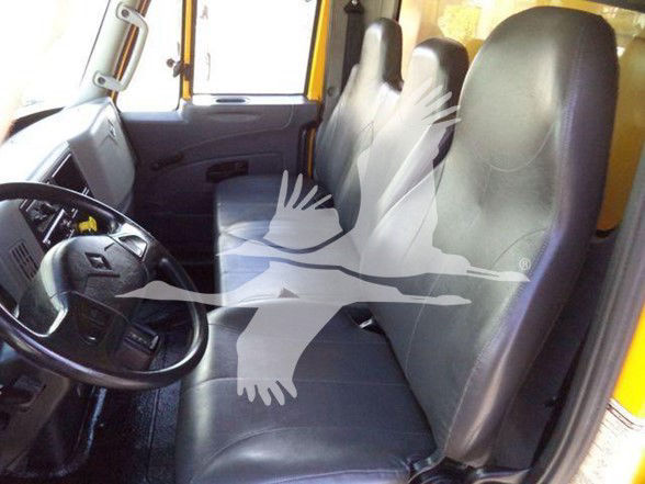 Truck cab interior showing steering wheel and two front seats from the driver side.