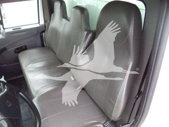 Interior of a 2019 International DURASTAR 4300 cab with front bench seat and grey upholstery. Visible seat belts and door panel.