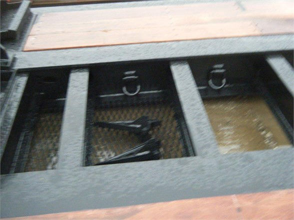 Talbert 55SA flat level deck trailer storage area showing tiedown rings and deck access with metal frame.