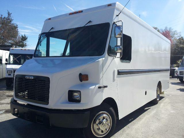 Boxy white 2005 Workhorse P42 step van side view showing large cargo box and front grille with Ford-like emblem.