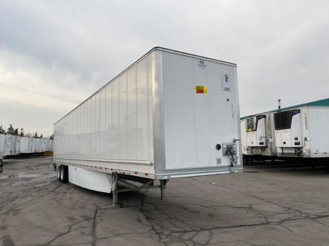 Hyundai dry van trailer in a used condition showing side and rear with lift legs, doors, and wheels visible.