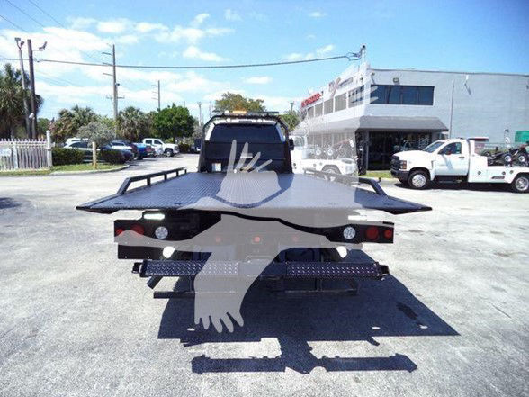Ford F-650 tow truck flatbed seen from rear with platform and lights. VIN/stock not visible in image.