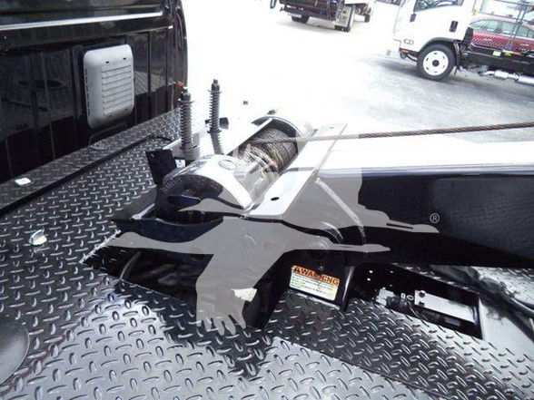 Ram 4500 tow hitch with winch on diamond plate bed, visible label and components.