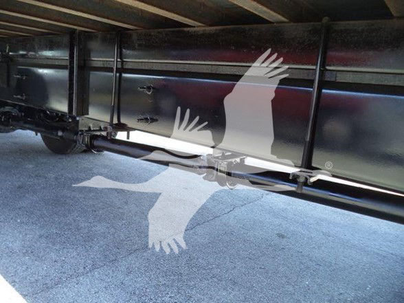 Underbody view of a box truck showing chassis and frame rail with a protective undercarriage. No legible labels visible in the image.